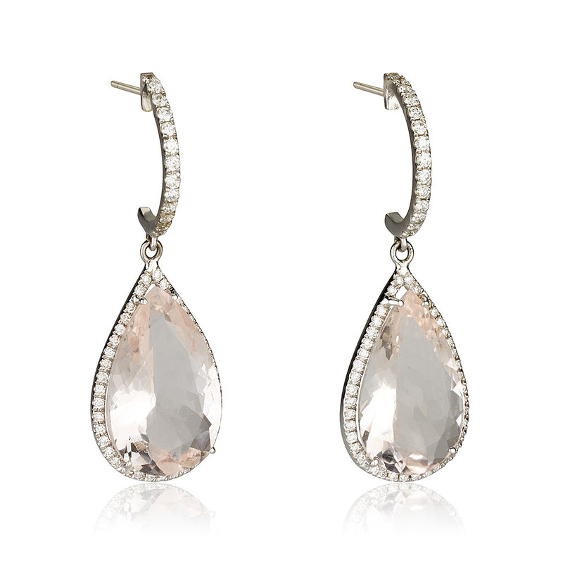 A dazzling pear shaped drop dangling earrings with diamonds