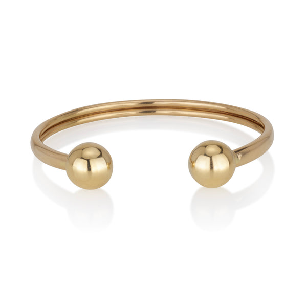 An open bracelet with two solid gold balls