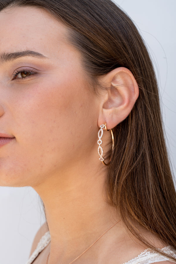 Cosmopolitan adorned hoop earrings with diamond pave geometrical patterns